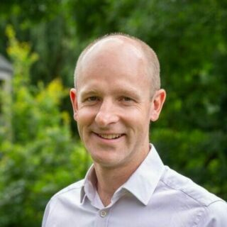 Roger Mawle, Trustee. A bald white male with a blue sweatshirt