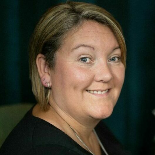 Close up photo of a female CAP client smiling and looking at the camera