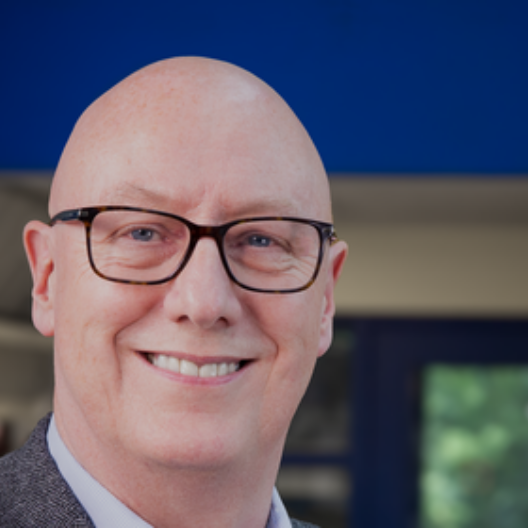 Stewart McCulloch, CEO of CAP UK, a white older male who is bald with glasses, smiling at the camera.