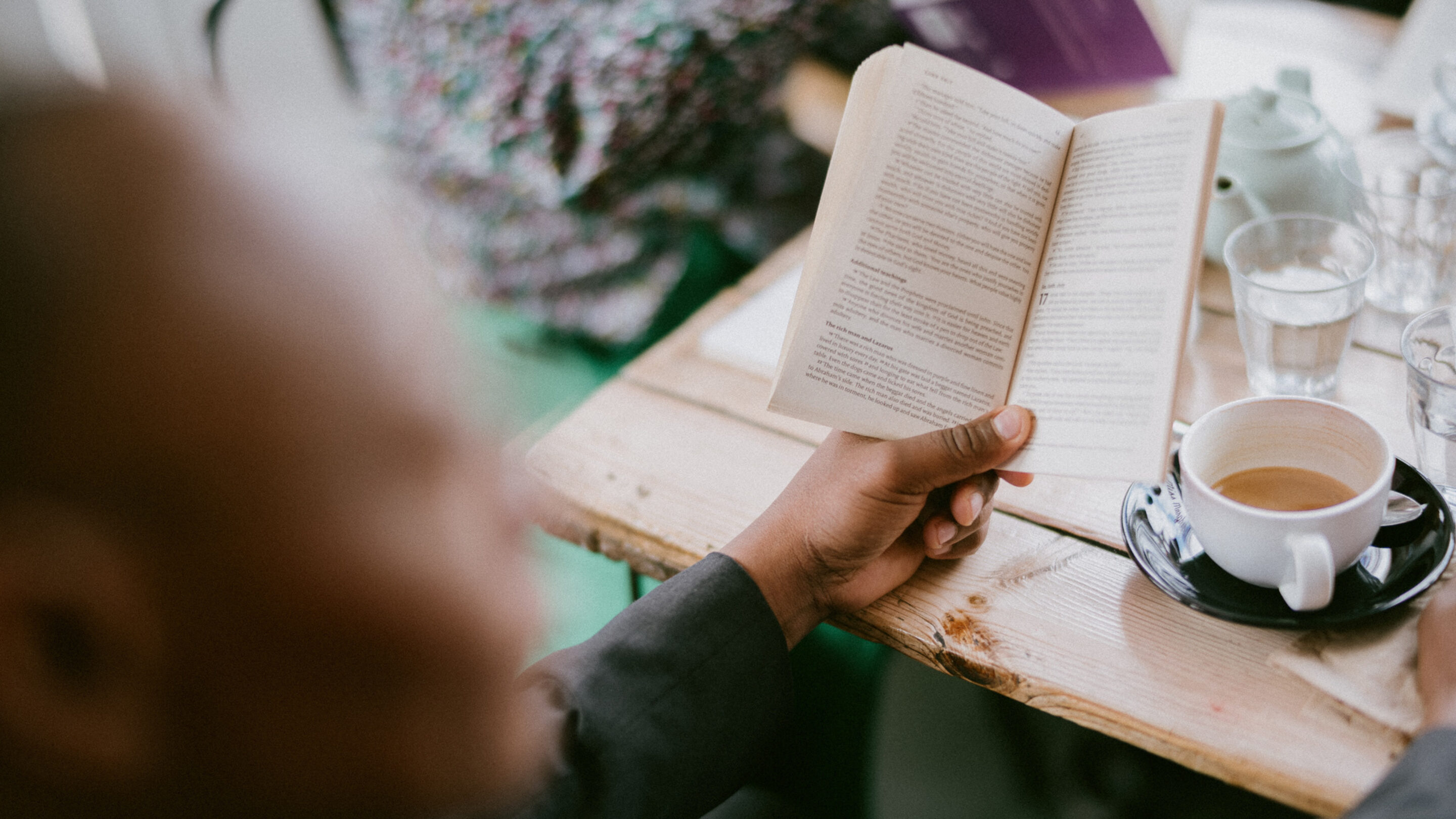 A CAP client reading a book in a group at a coffee shop