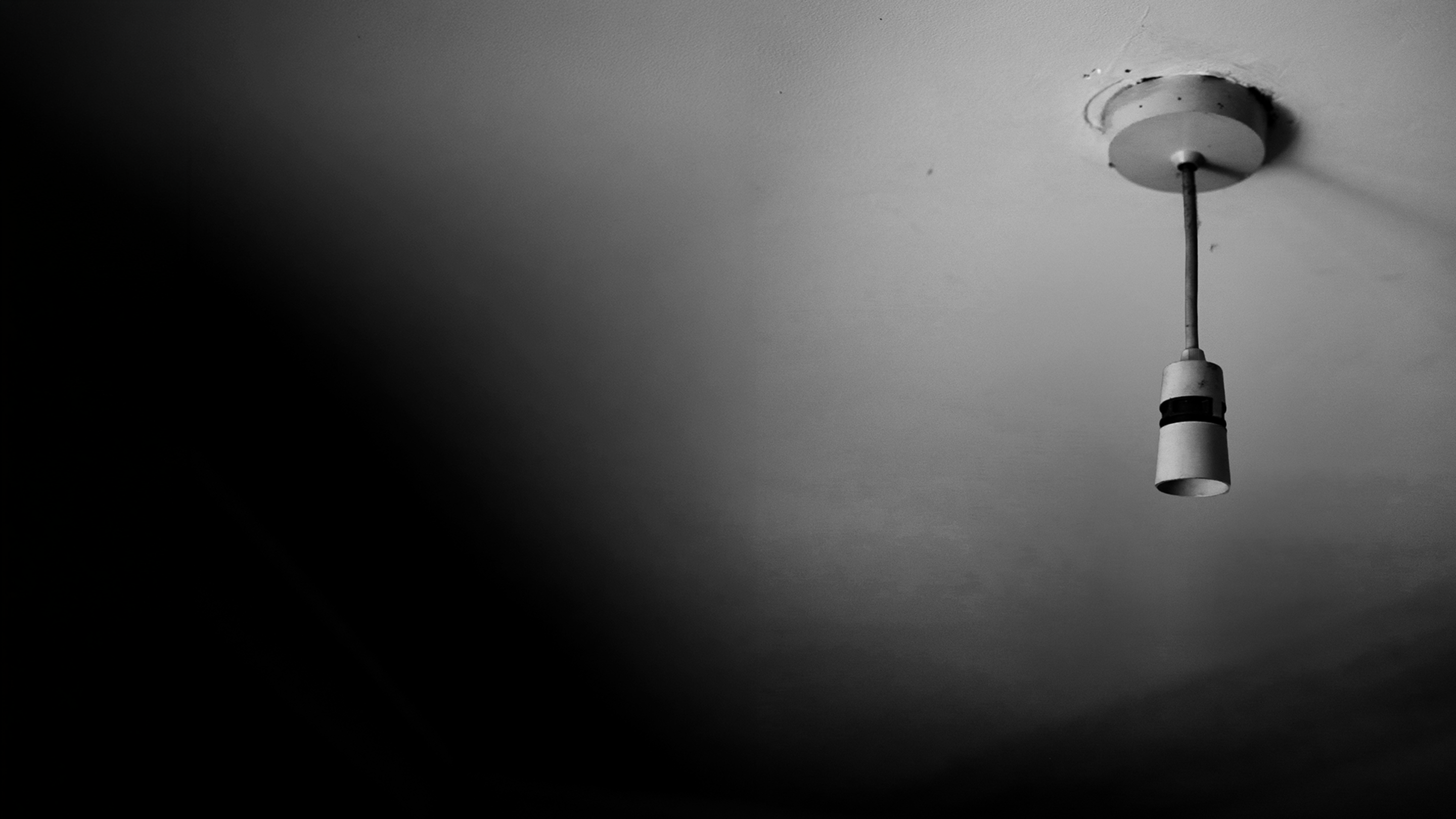 Bare lightbulb fixture in a dark room