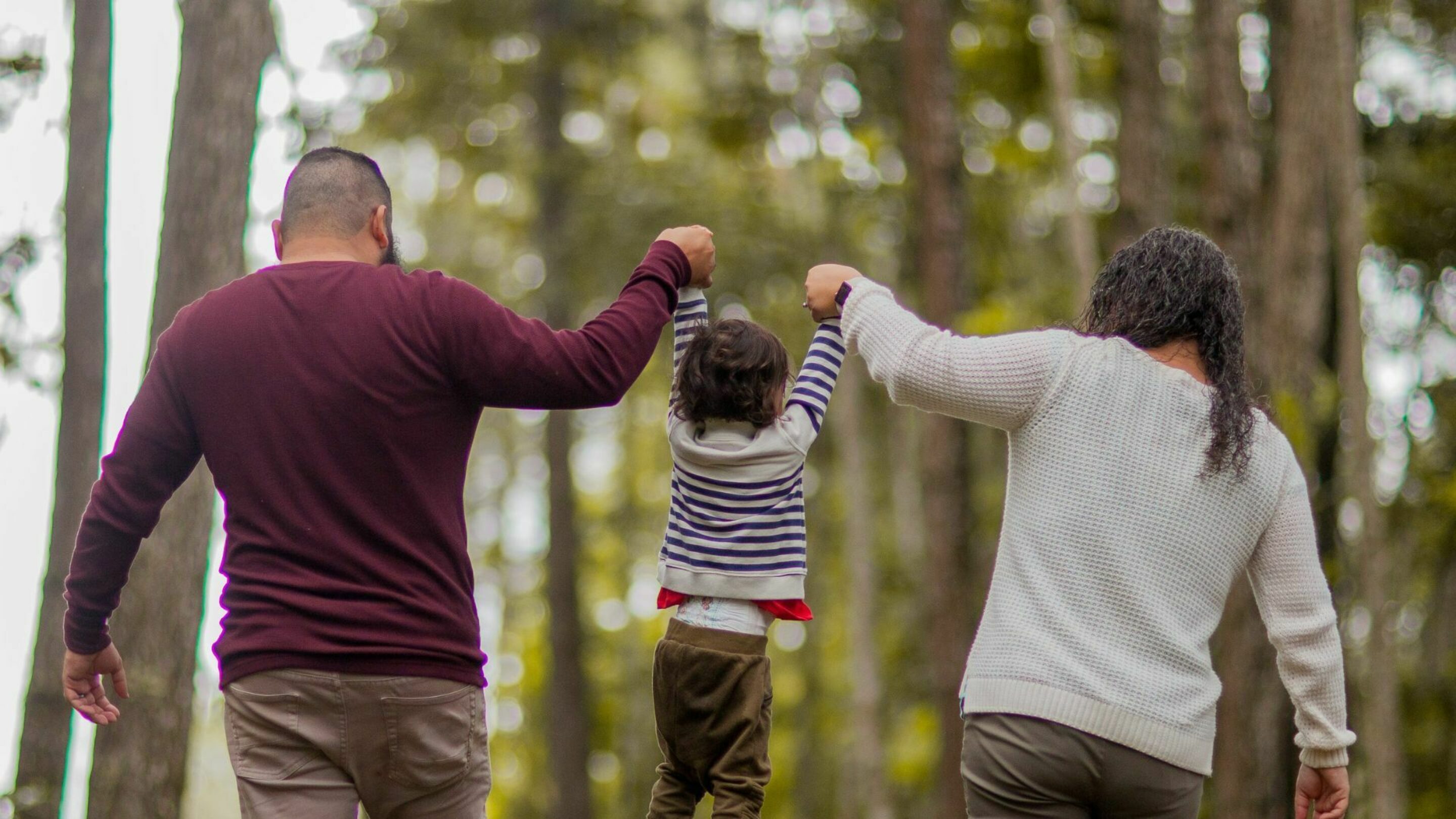 Man and woman carrying toddler. Photography by Caleb Oquendo.