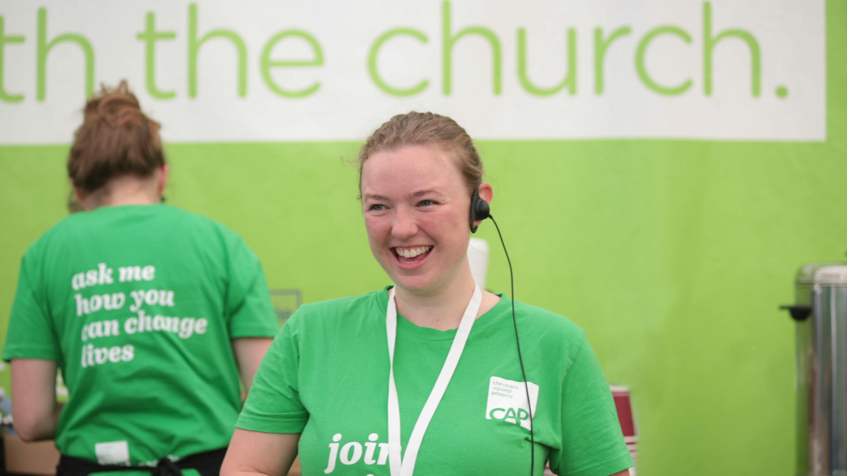 Young woman wearing a headset smiling.