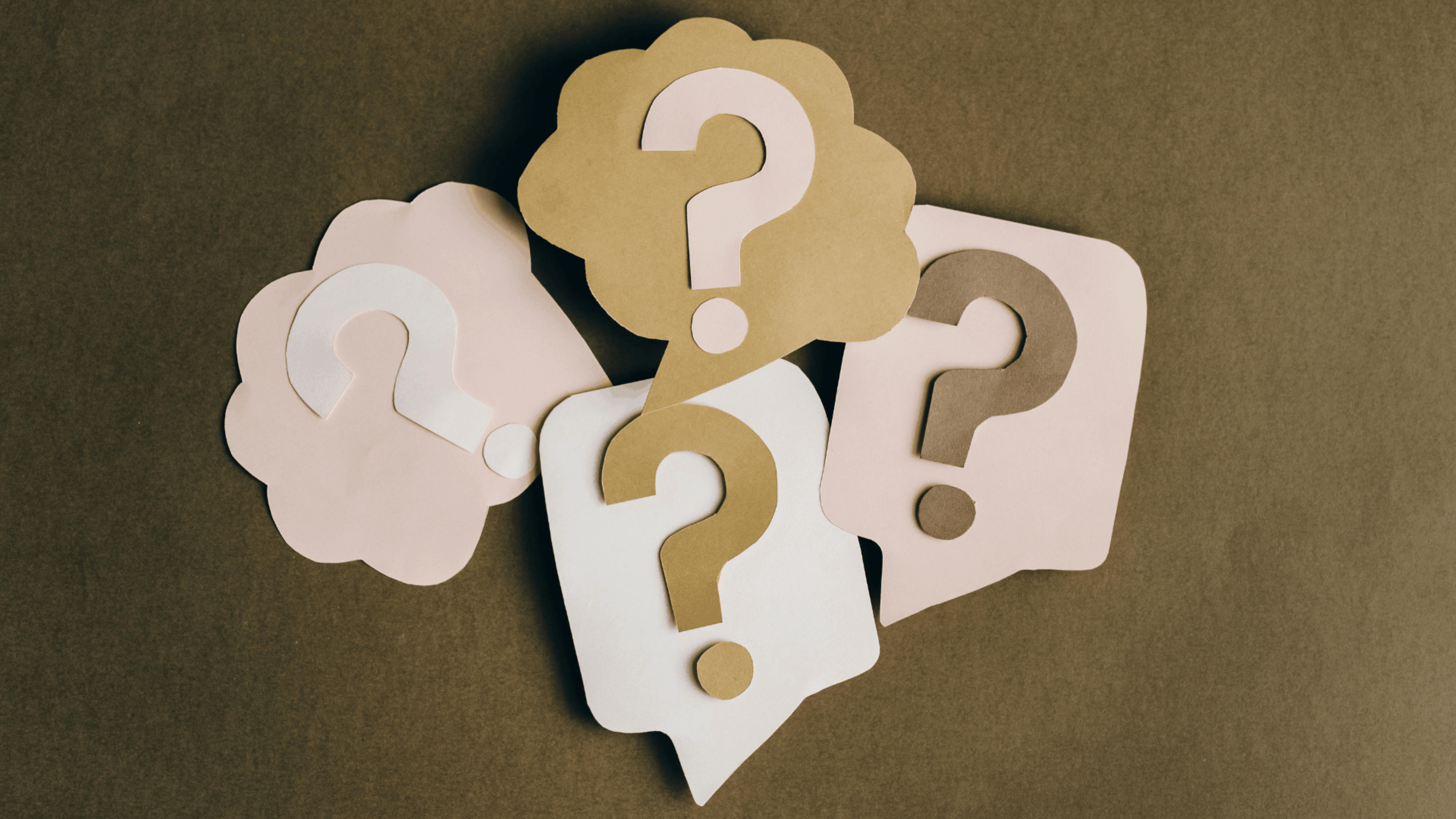 A bunch of question marks in a combination of thought or speech bubbles, cut out of card and stacked upon each other Photography by Leeloo The First.