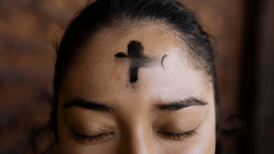 A woman with ash placed in the shape of a cross on her forehead. Photography by Annika Gordon.