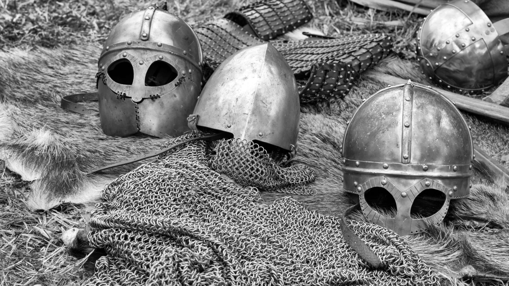 A selection of helmets and other body armour laying on the ground.