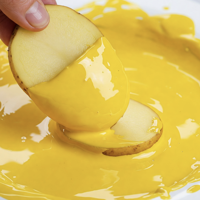Image of a potato slice dipped in bright yellow paint