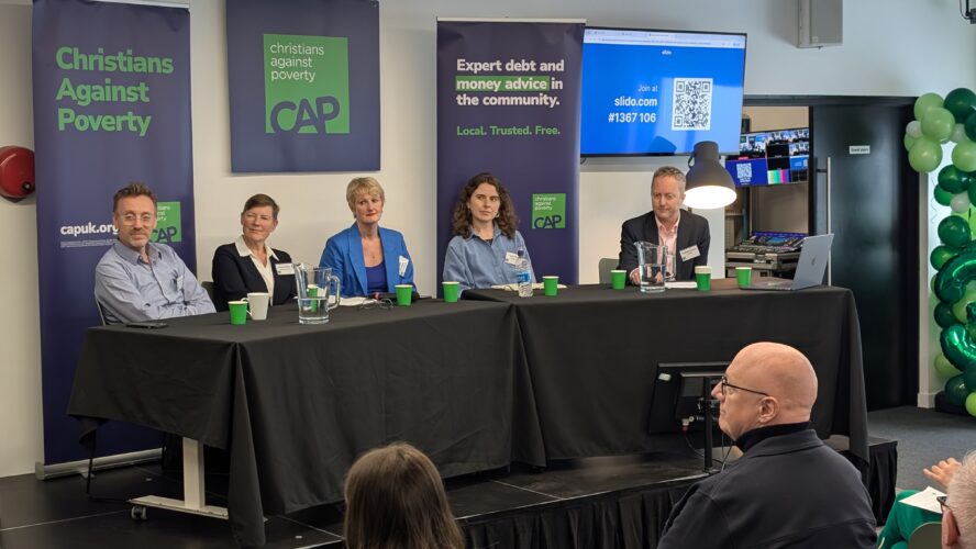 A panel of people from different sectors sat at a long table, answering questions at CAP's Insight Day