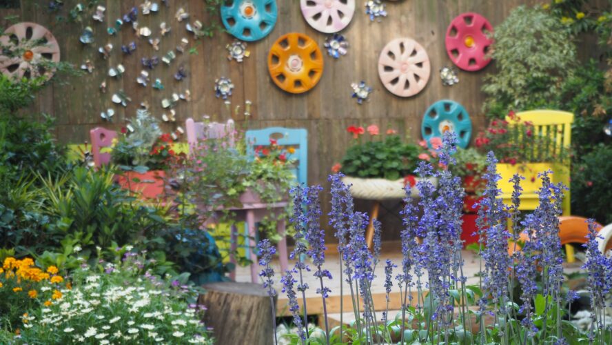 A garden with a colourful fence and colourful garden furniture
