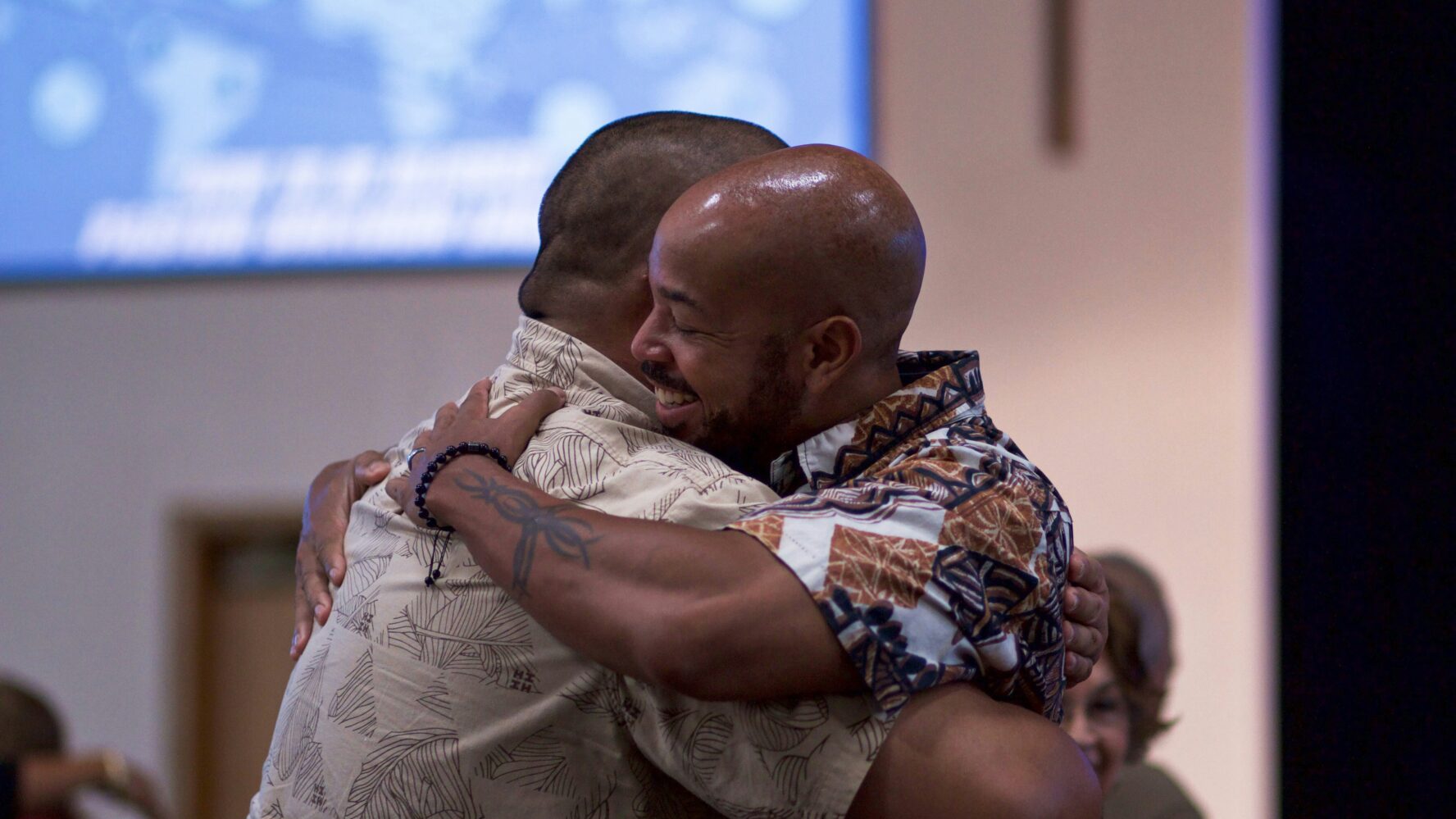 Image of two men hugging in their church