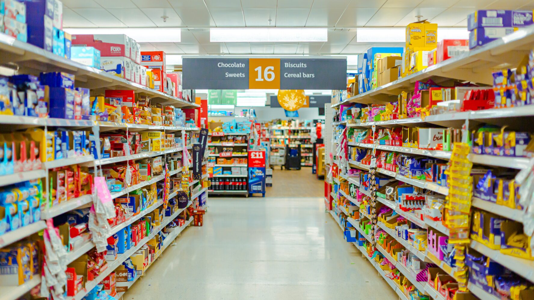 Image of a Sainsbury's supermarket sweets and snacks aisle.