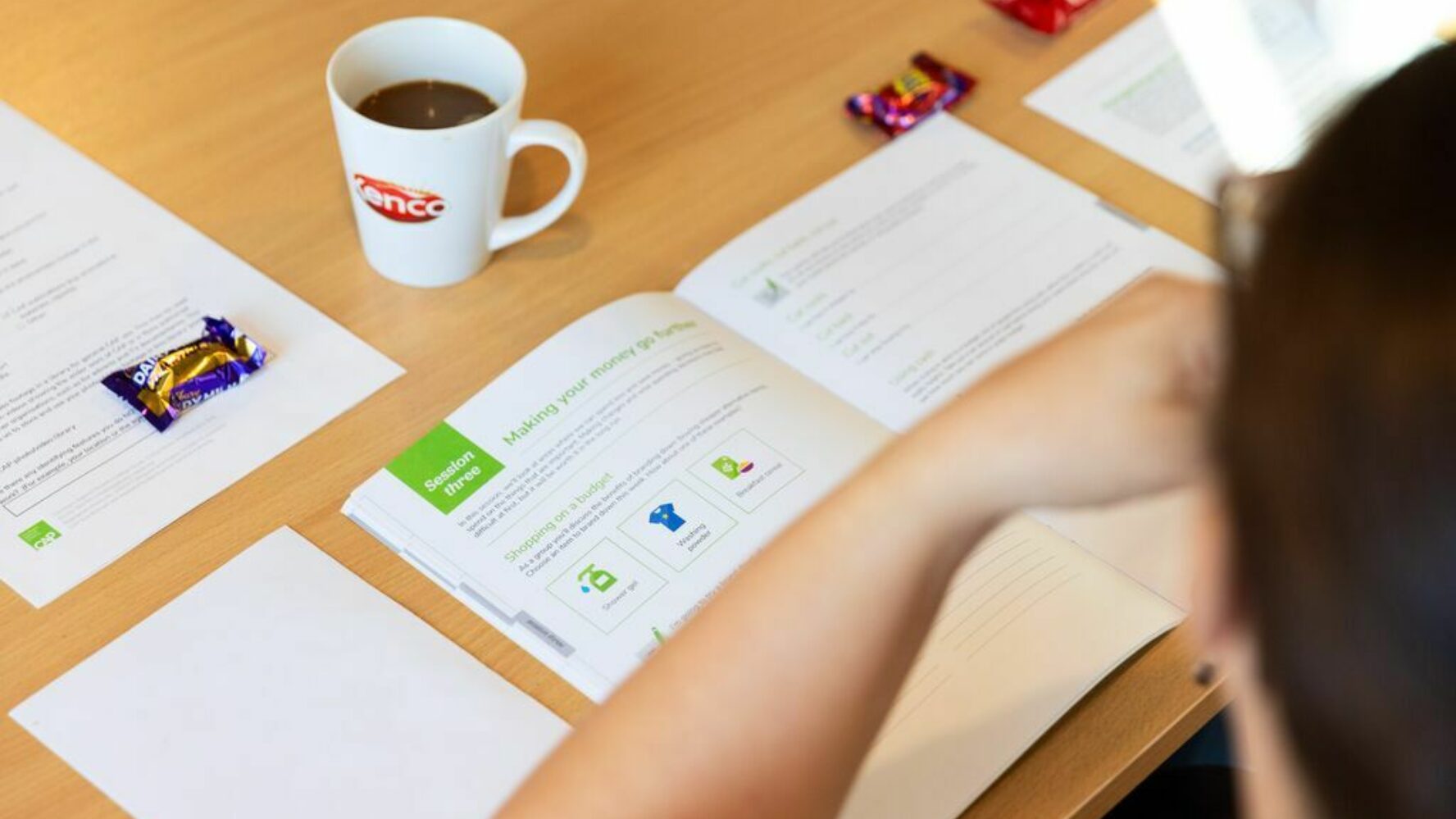 Photo of table with booklet and mug