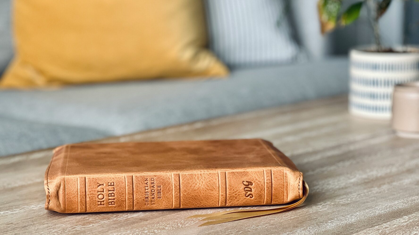 Image of a leather Bible on a brown coffee table in a living room