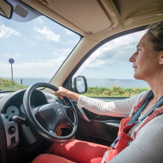 Debt Coach Melissa in her car, driving (often many miles) to visit clients