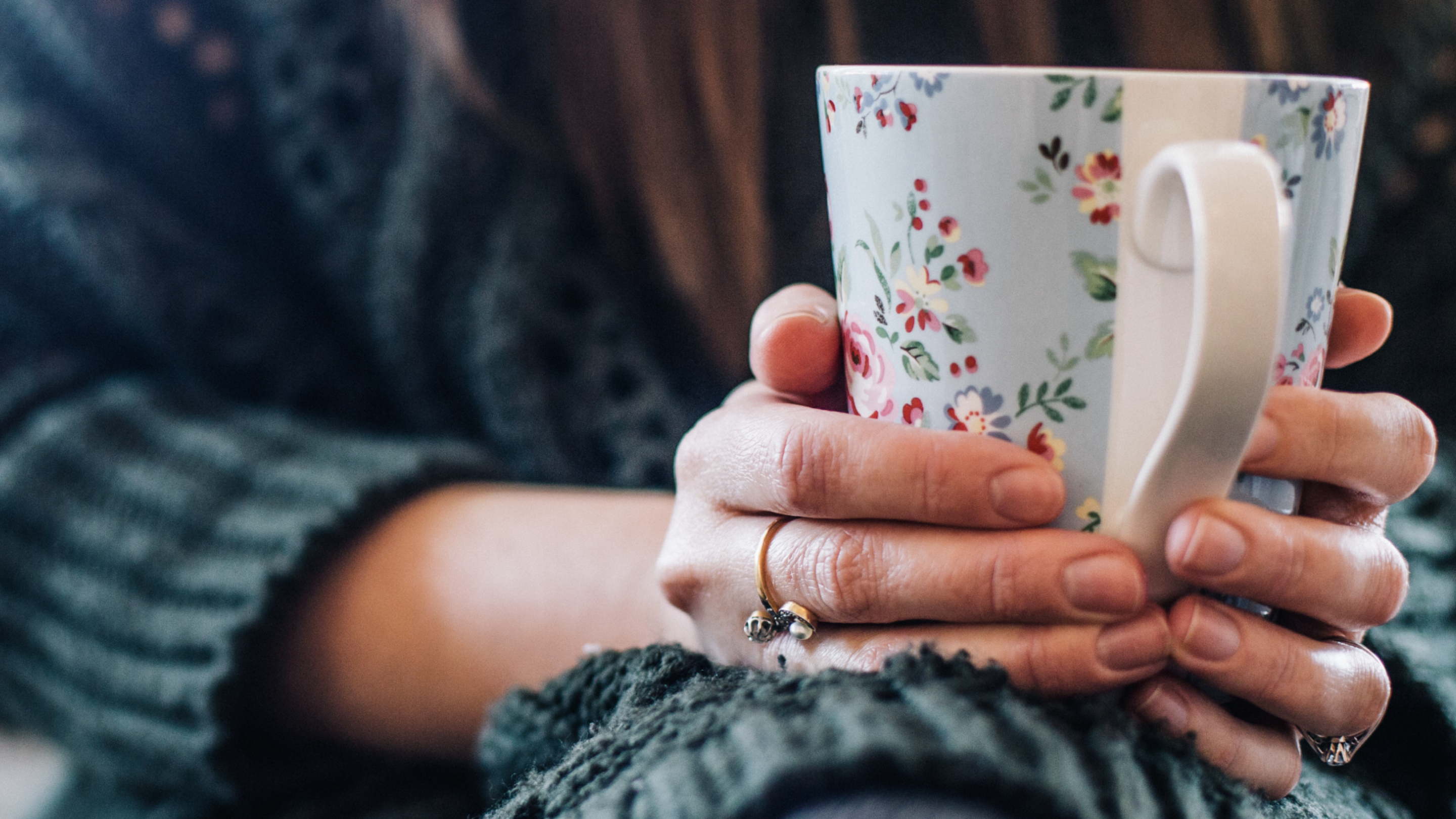 Photo showing a person holding a mug