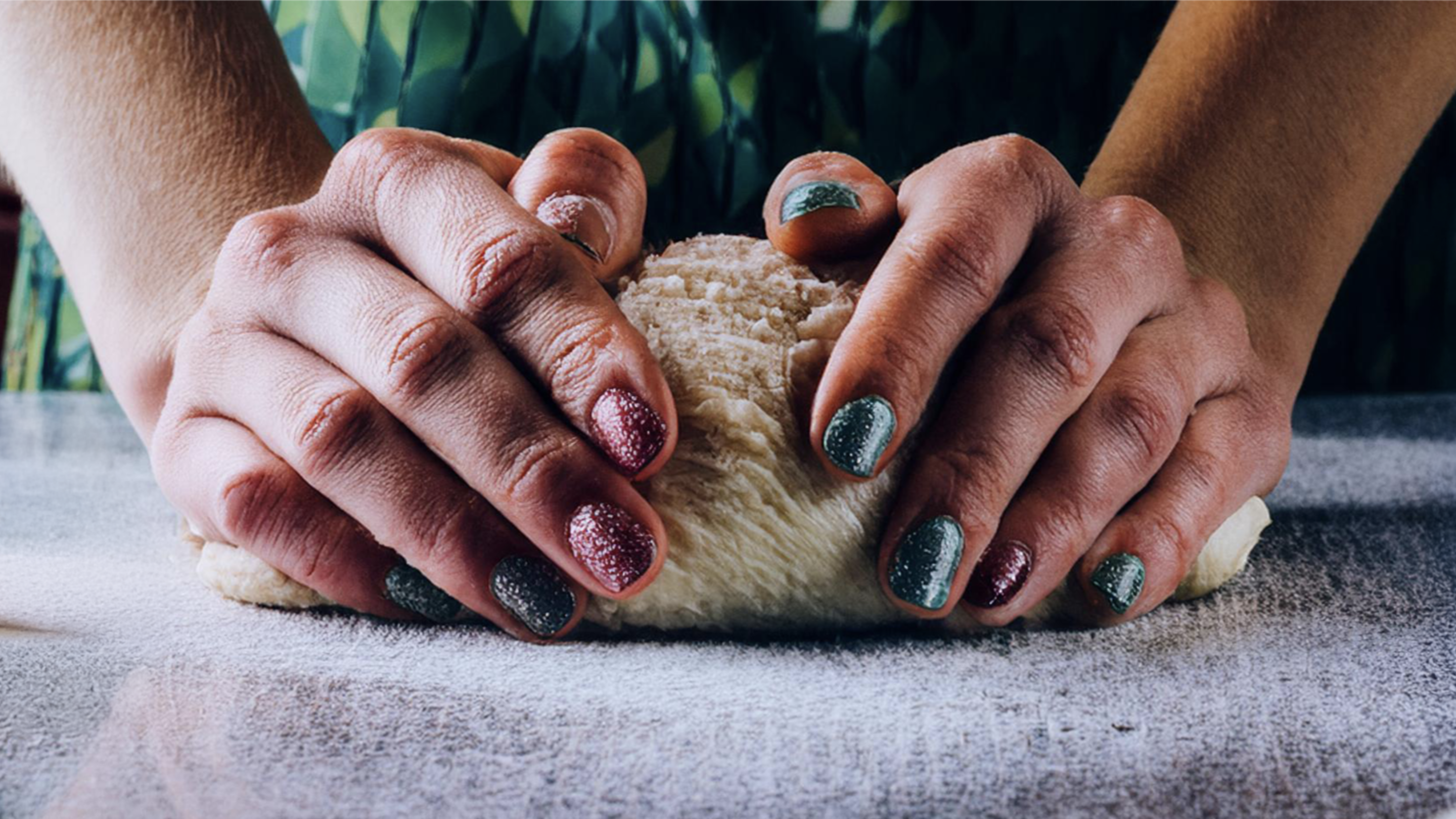 Person baking bread and holding dough