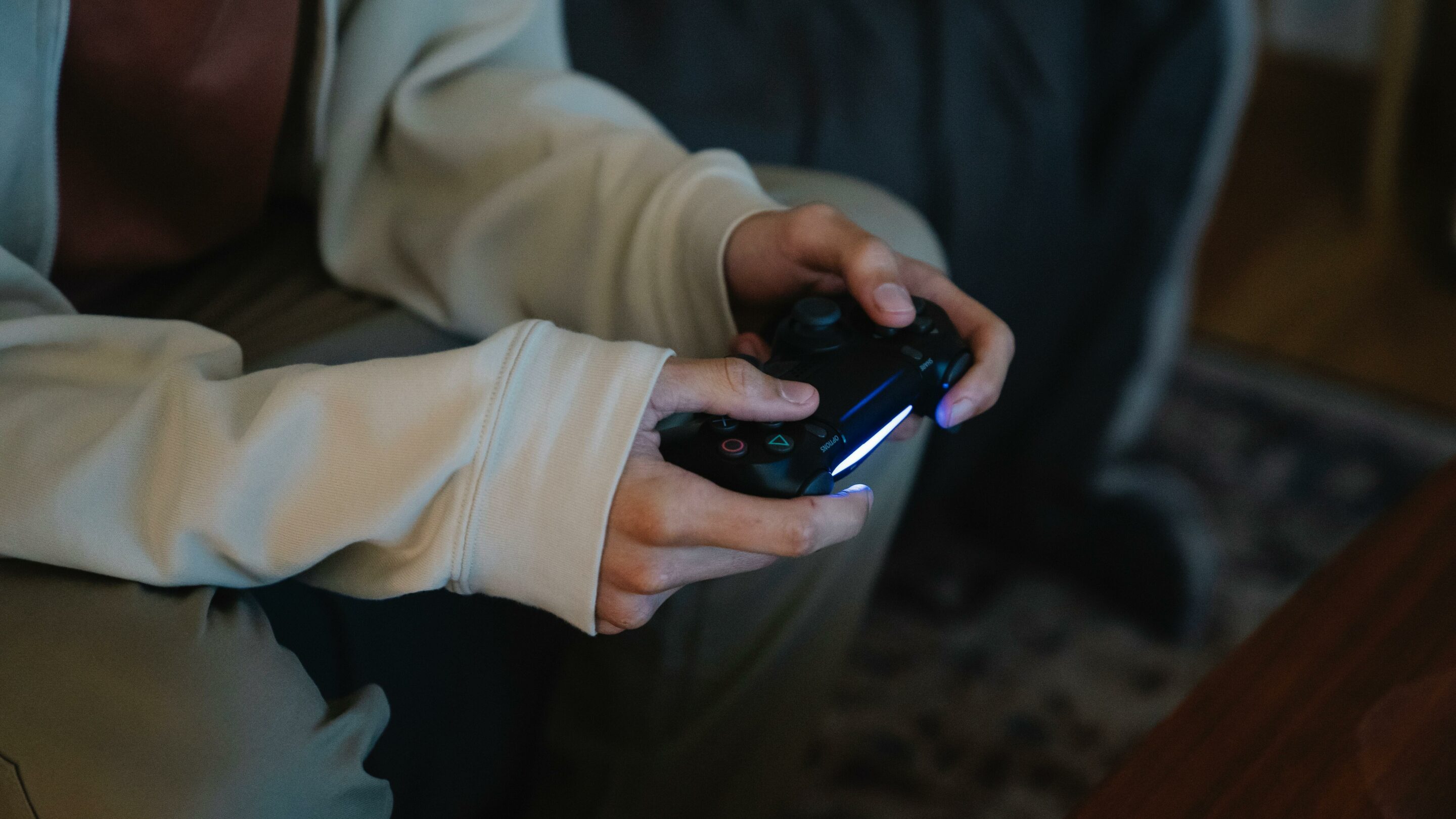 A close up of someone's hands using a game controller.