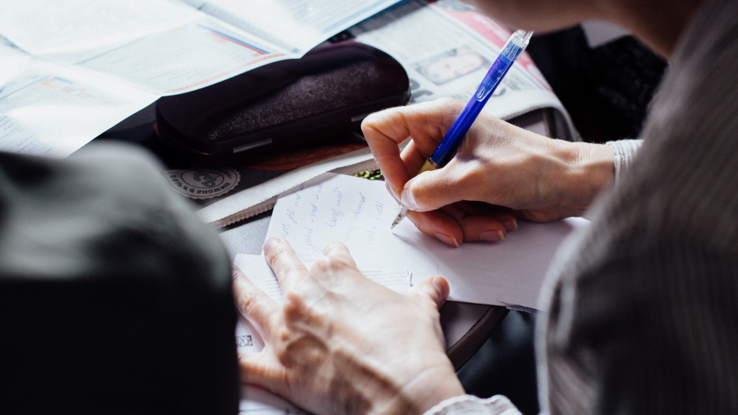 Image of a person writing notes on paper