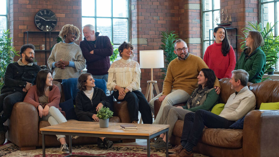 people gathered on sofas round a coffee table