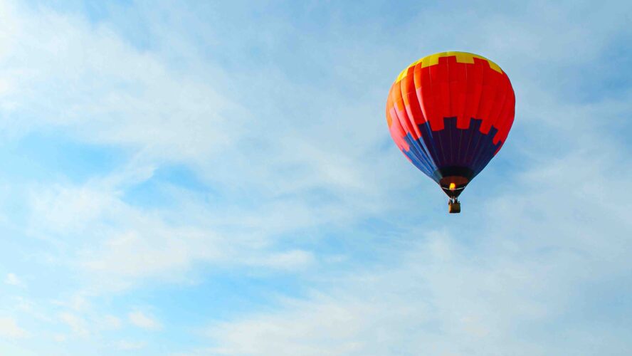 Colourful hot air balloon flying in the sky.