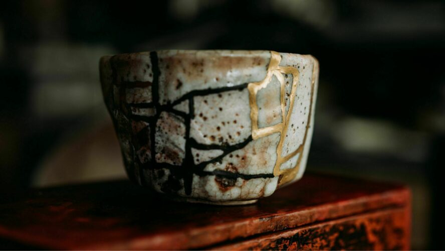 A broken pot stuck back together using gold, a Japanese technique known as Kintsugi, which adds value to the original piece.