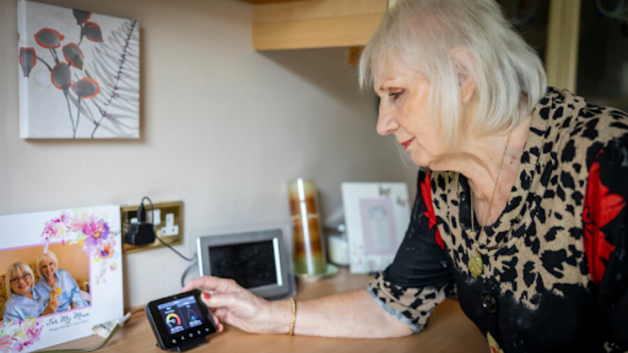 An older lady looking at her thermostat readings