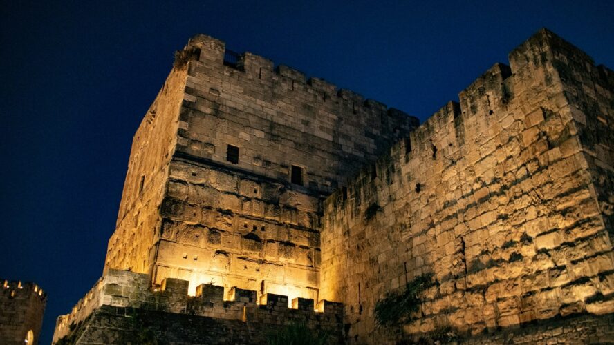 A building in an old town at night, lit up with lights