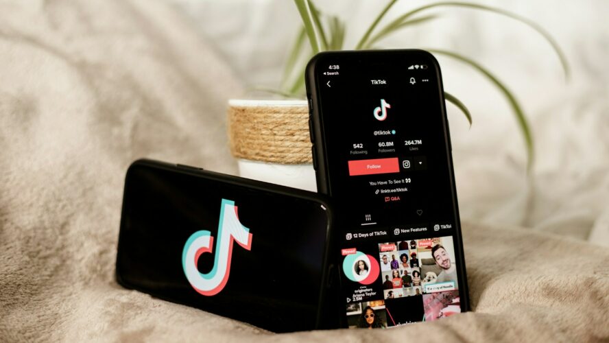 Image showing two smartphones displaying the TikTok app and logo