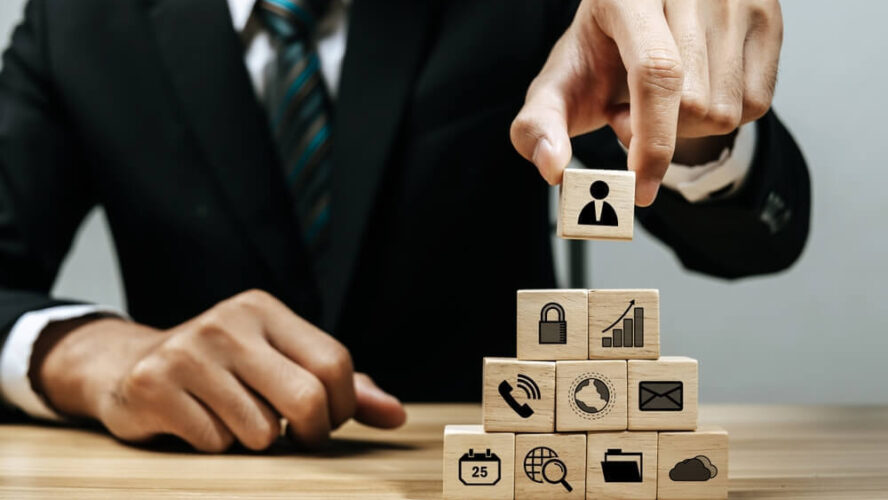 Man in suit building blocks