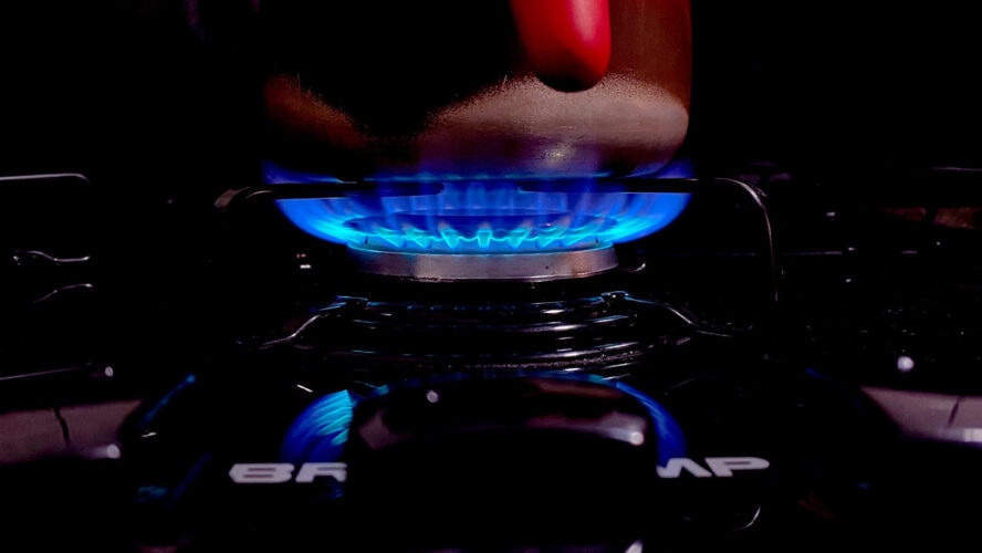 A lit gas burner hob.