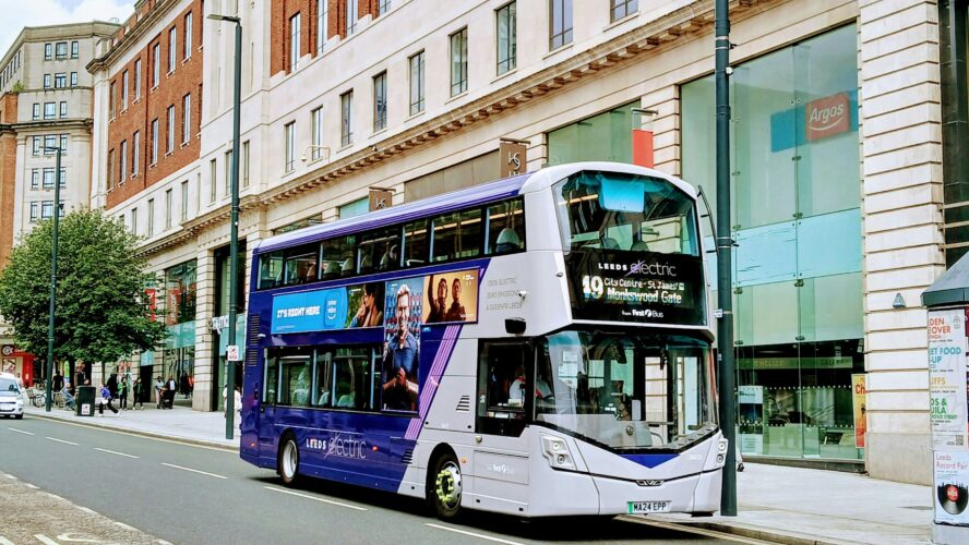Blue and white bus on a high street