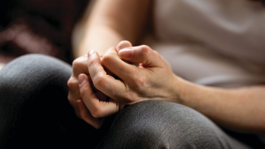 woman clasping hands