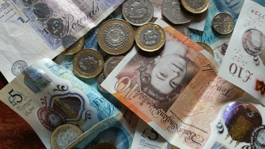 Notes and change in cash on a table.