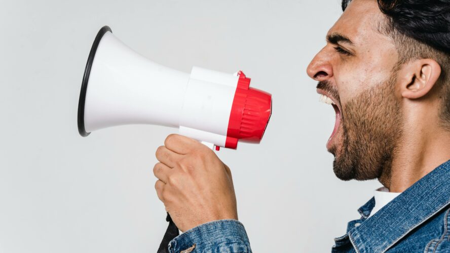 A man shouting into a megaphone.