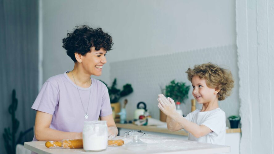 A mum and child baking together in the kitchen.