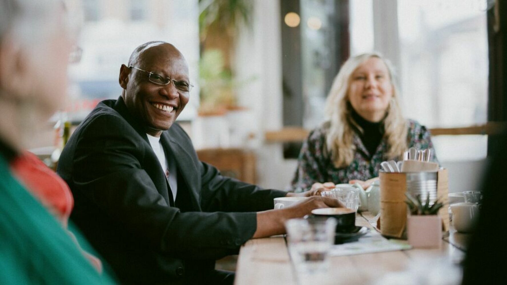 A church community group setting around a table in a cafe