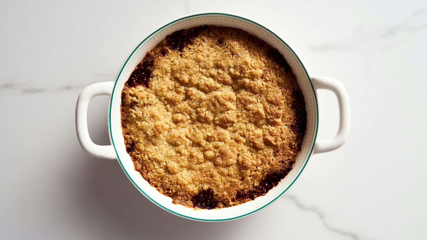 A crumble in a round baking dish on a white countertop