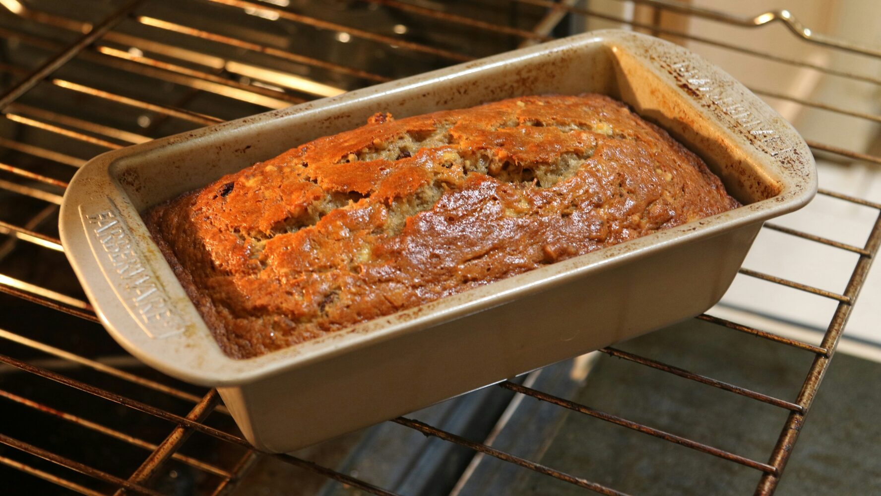 A banana bread in a baking dish, freshly baked out of the oven