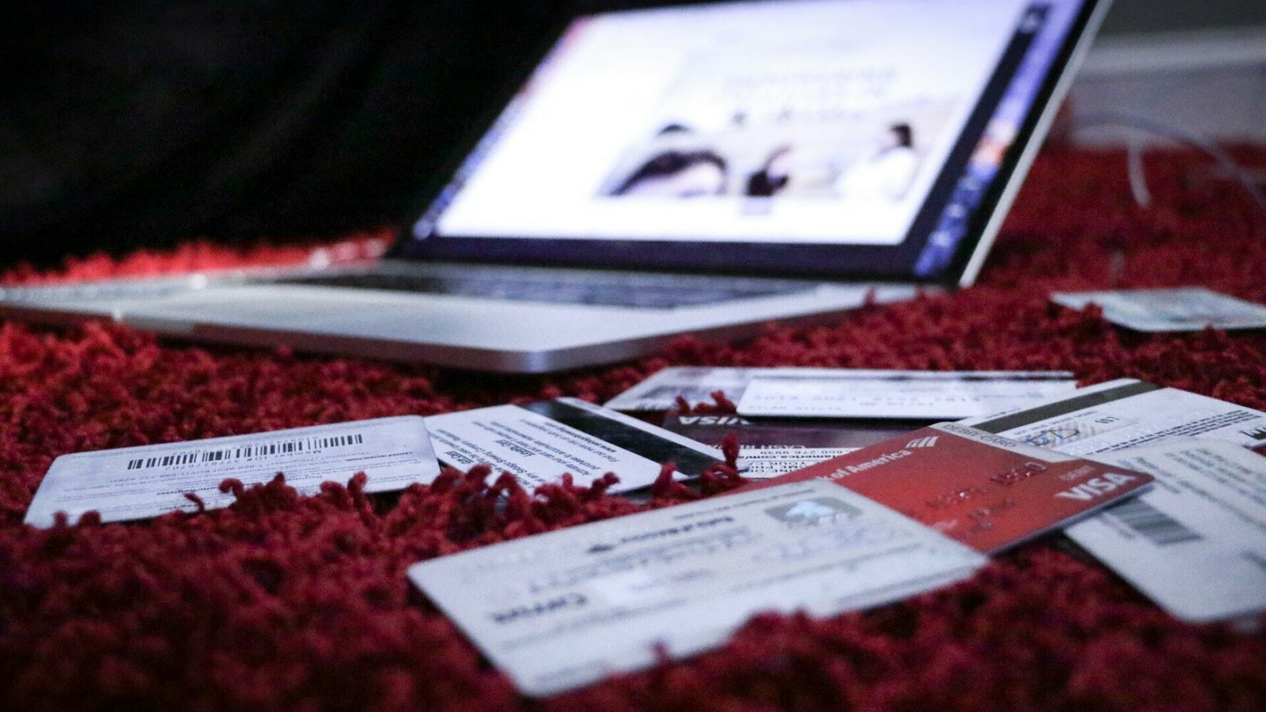 Scattered credit cards and an open laptop