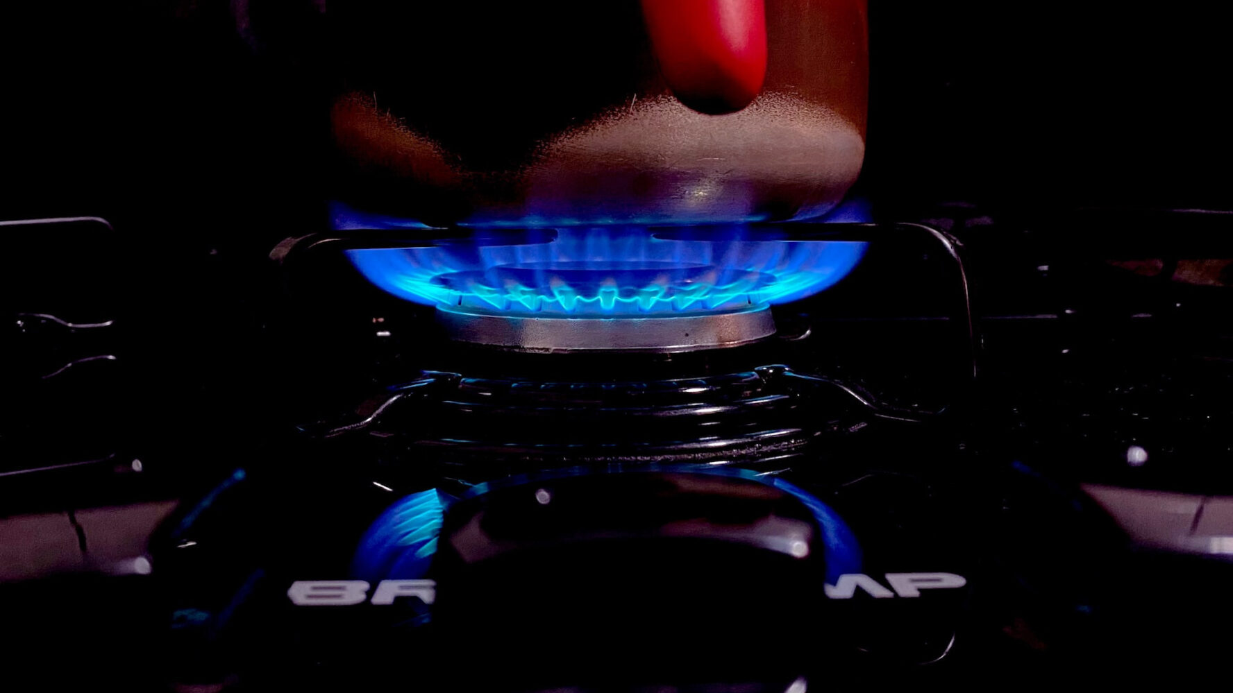 A lit gas burner hob.