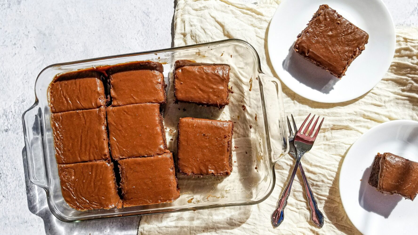 Chocolate fudge cake bites cut into squares in a clear baking dish
