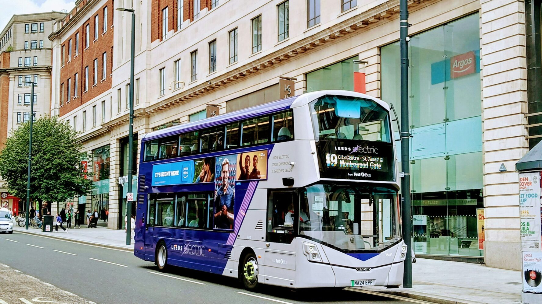 Blue and white bus on a high street