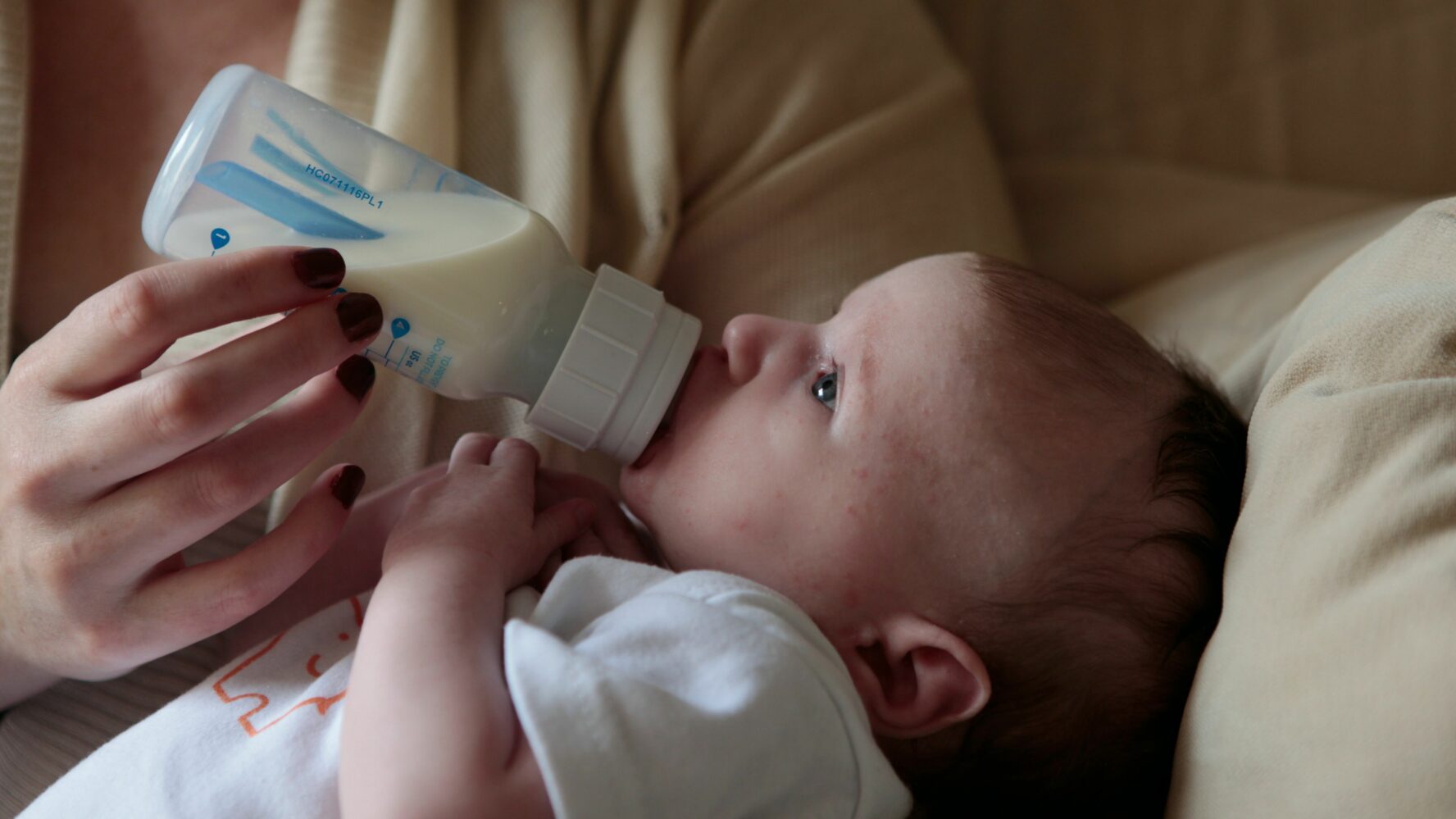 Baby with bottle of milk