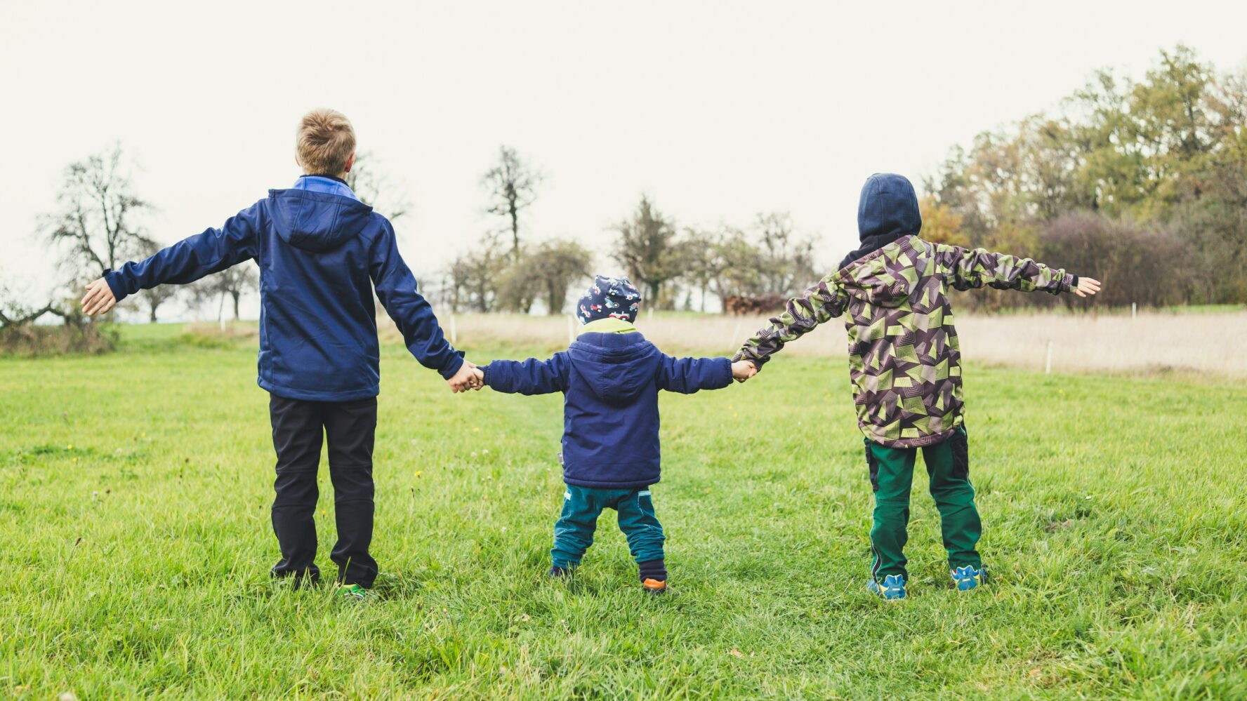 children outside holding hands