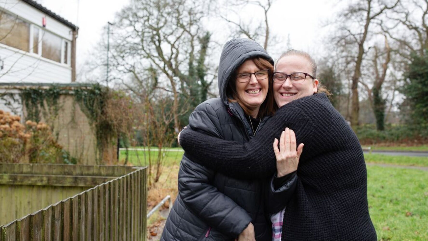 Image of a CAP client and her befriender stood outside hugging