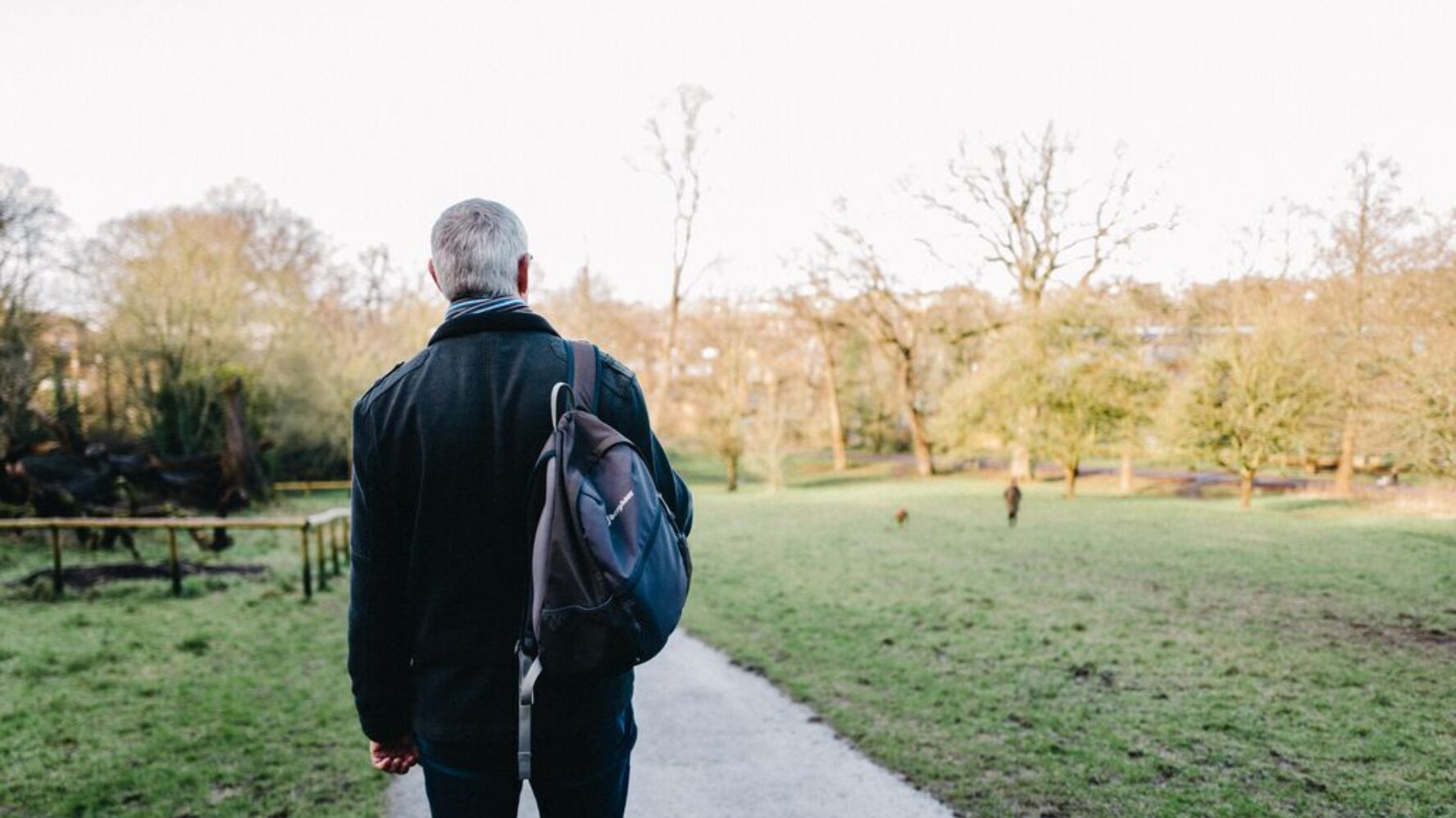 CAP debt coach walking through a park, looking out at nature