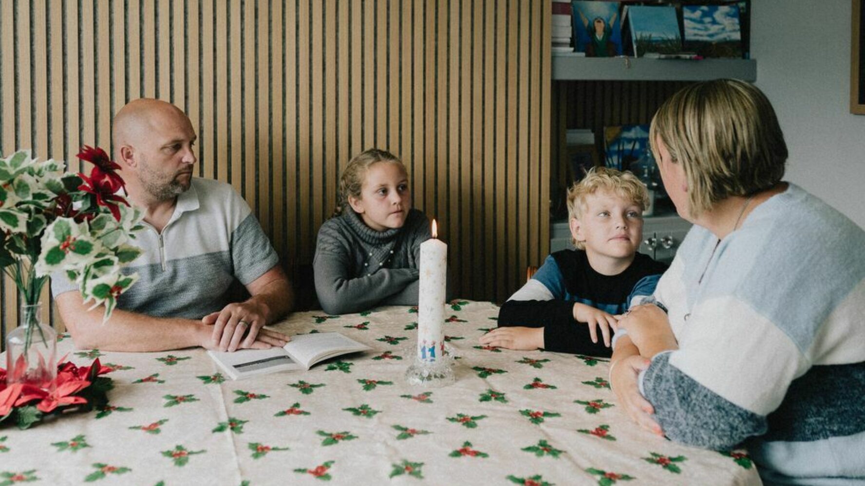 Image showing a family sat around a dining table, with the parents talking to their children who are listening