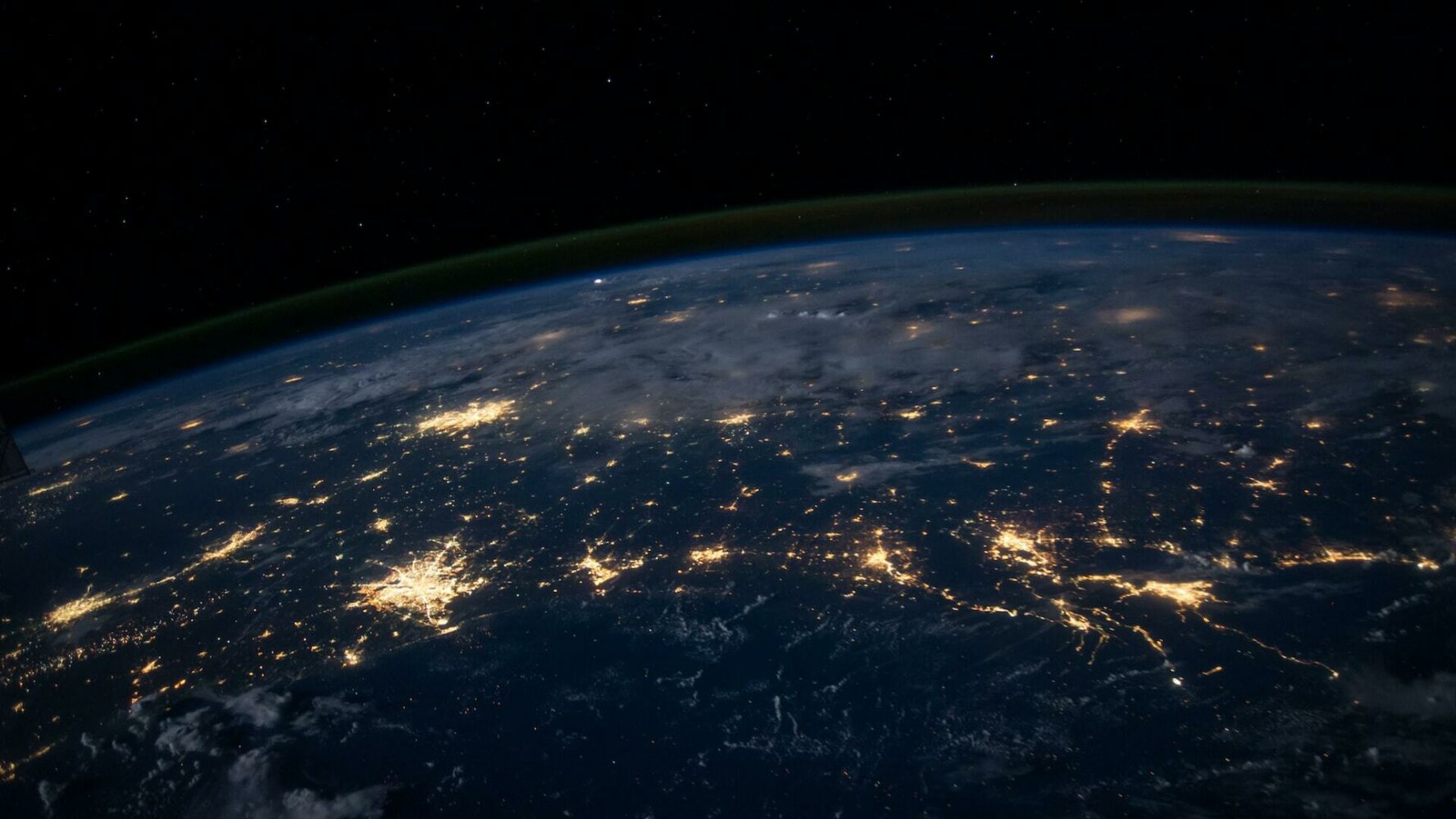 Cities on the earth lit up by electricity viewed from space.