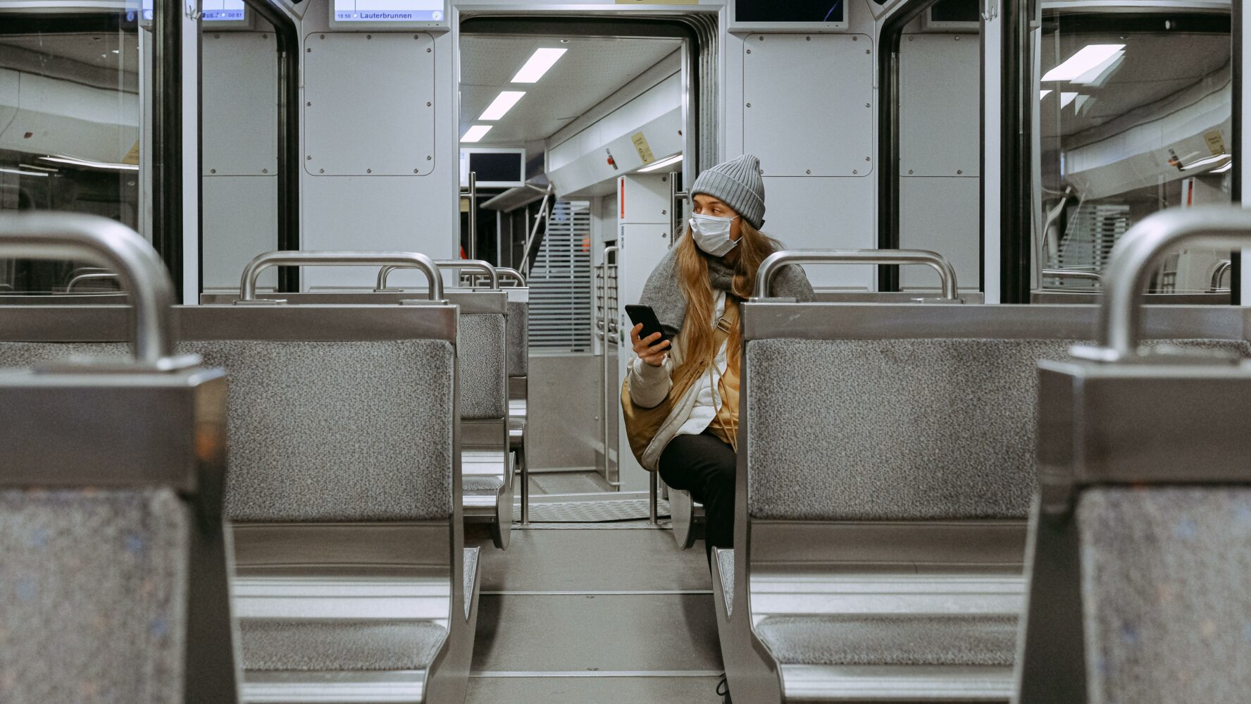 A woman riding the subway wearing a mask during the COVID-19 pandemic.