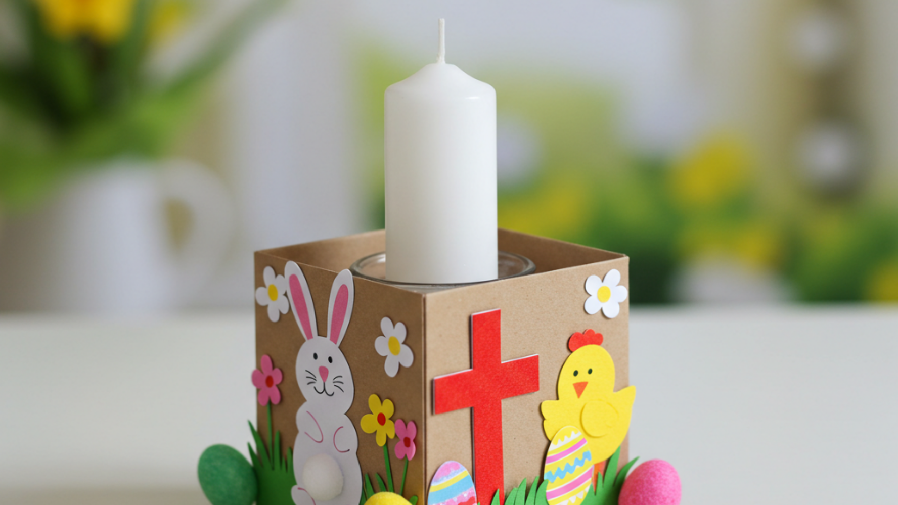 Easter craft of a cardboard box turned into a candle holder, with easter stickers on the front